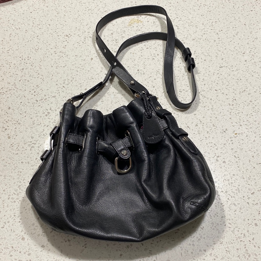 Black. Super soft leather! Adorable drawstring bag! Silver hardware.
